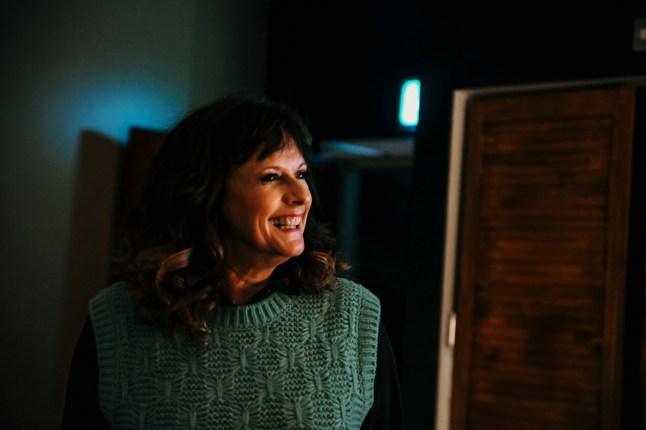 Sian Reeves looking to one side and smiling