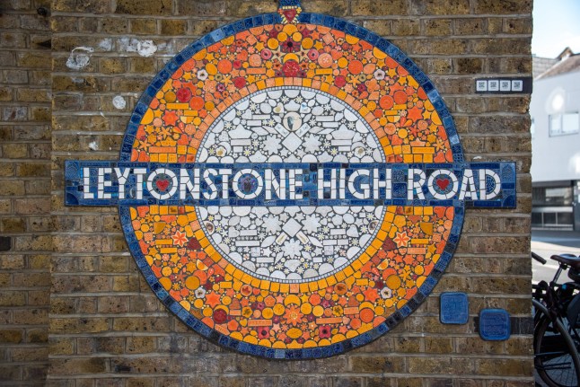 Leytonstone High Road mosaic shaped as Underground station roundel by Maud Milton, created with the help of the local community and installed in 2020 on a brick wall by Leytonstone High Road overground station in London, UK
