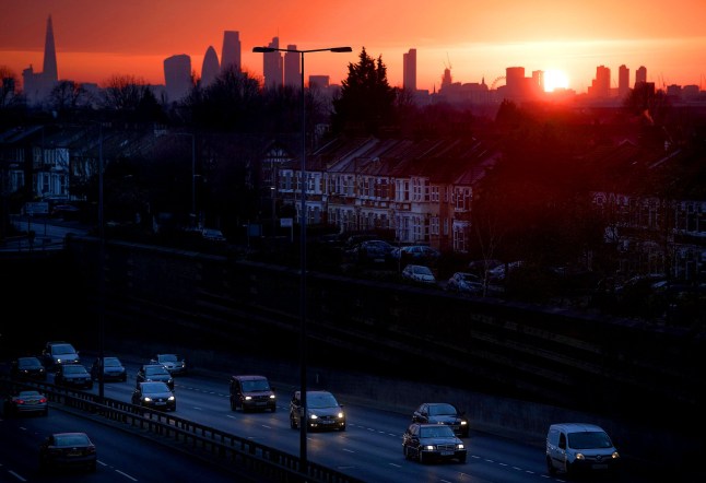 Mandatory Credit: Photo by Ben Cawthra/Shutterstock (4339728c) The sun setting behind the city of London seen from Leytonstone in East London with traffic on the A12 road in the foreground Sunset over London, Britain - 30 Dec 2014
