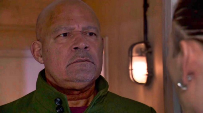 Donny Clark looks unnerved as he talks to Sully in a hallway