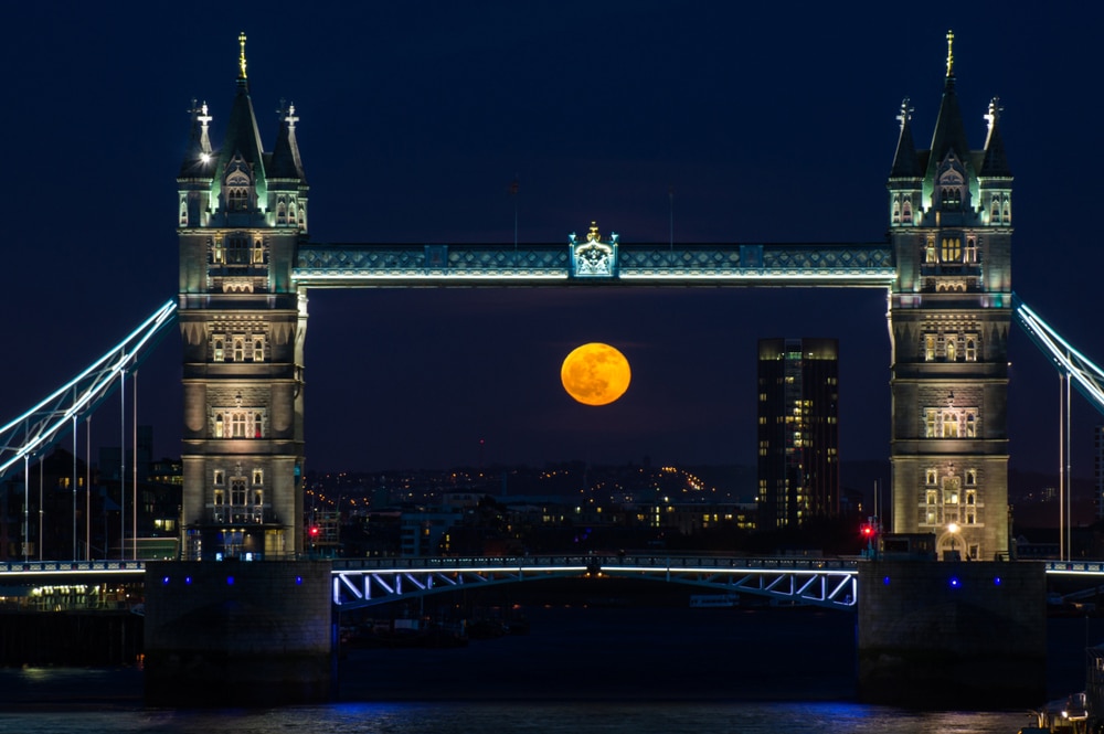 A full moon rising over Tower Bridge in 2014.