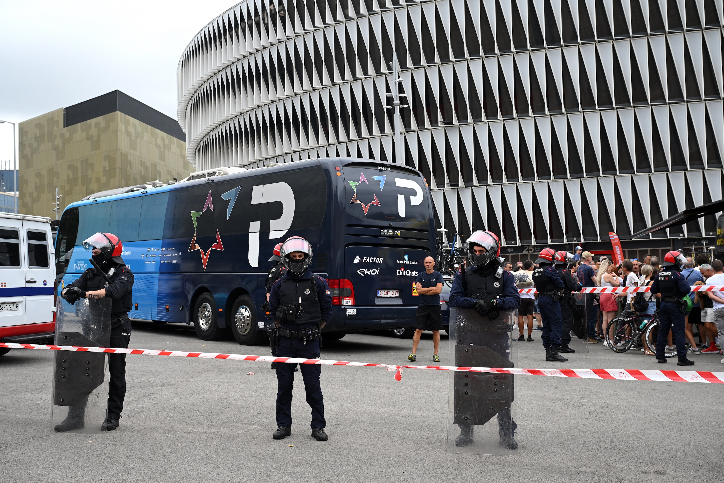 The Israel-Premier Tech bus surrounded by riot police