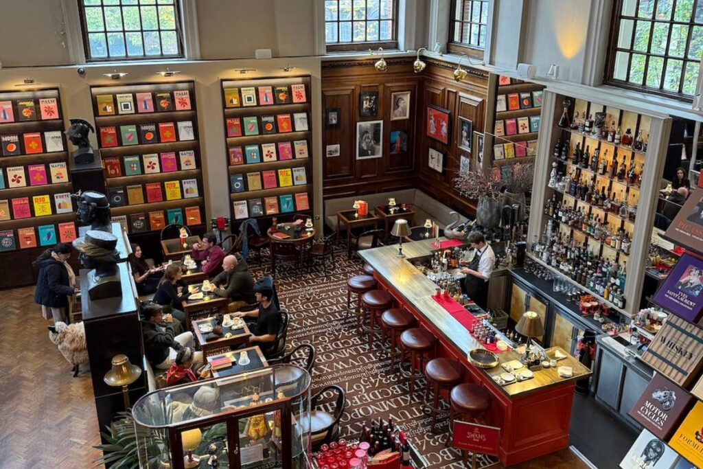 Image from above shwing the bookshelves with some tables in front of them with a bar to the right