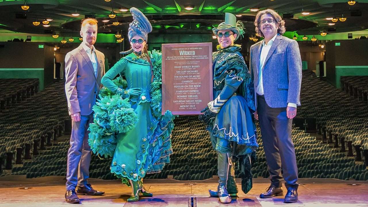 People standing alongside a plaque. Wicked becomes 9th longest-running show in West End history. Photo by Troy David Johnston