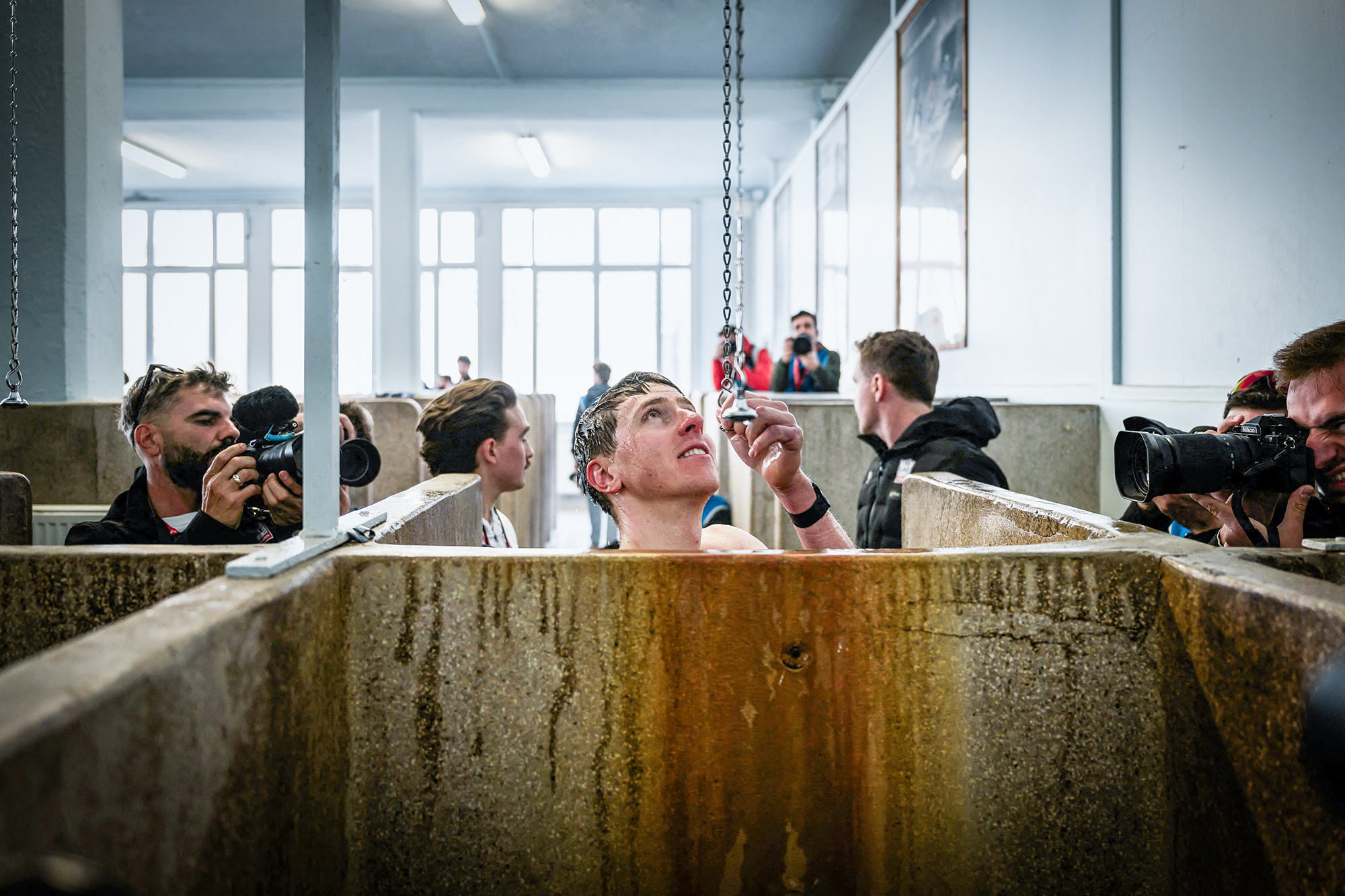 TOPSHOT - UAE Team Emirates' Slovenian rider Tadej Pogacar showers at the end of the 122nd edition of the Paris-Roubaix one-day classic cycling race, 259,2 km between Compiegne and Roubaix, northern France on April 13, 2025. (Photo by JEFF PACHOUD / AFP) (Photo by JEFF PACHOUD/AFP via Getty Images)