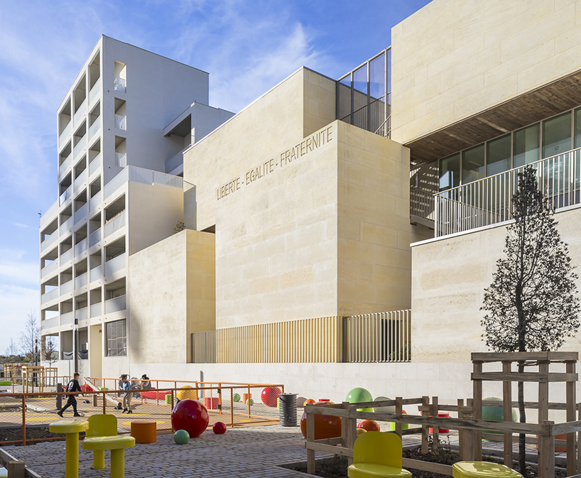 interlocking stone volumes sculpt layered school complex by brenac & gonzalez & associés