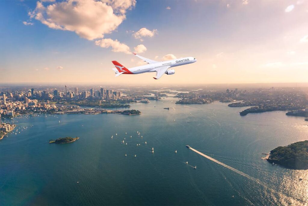 An aircraft flying over Sydney Harbour at sunrise