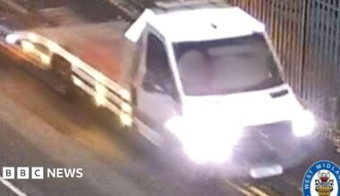 The image is of a blurred white van with its lights on. There is a West Midlands Police logo in the bottom right corner.