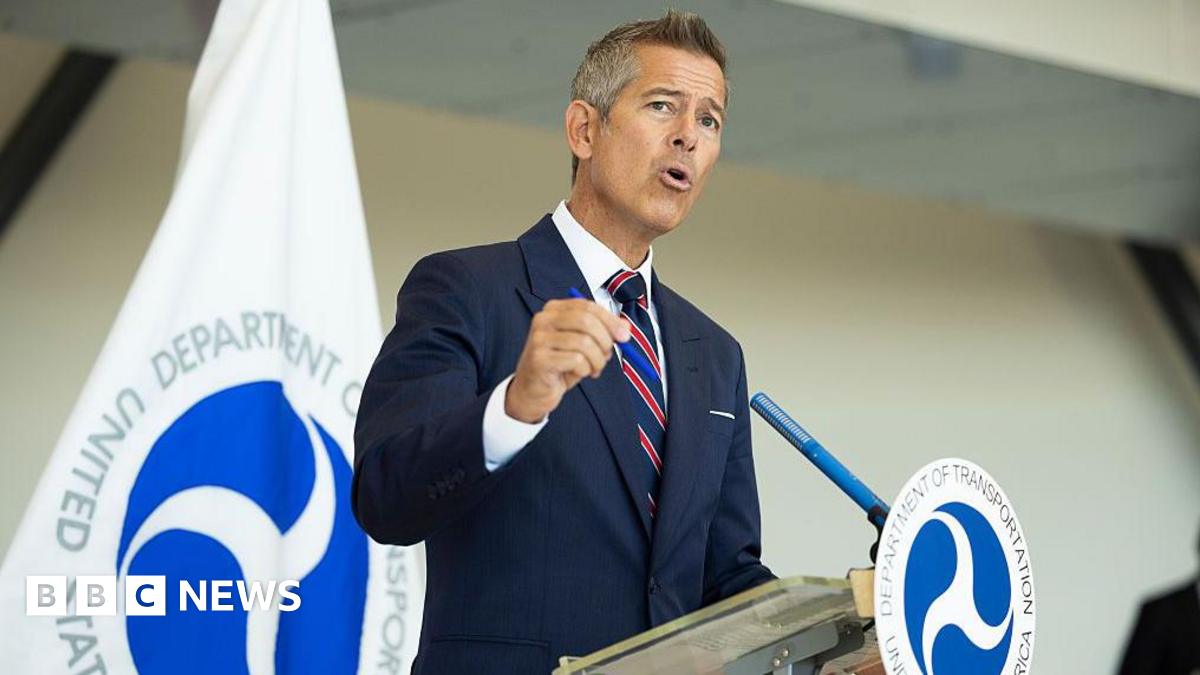 Sean Duffy stands at podium with transportation emblem