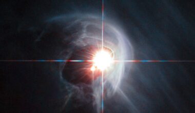 Two stars blazing within a wispy gas cloud in space