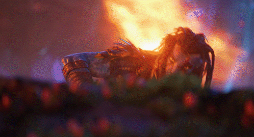 GIF of Jake Sulley in battle in Avatar: Fire and Ash with flames behind him