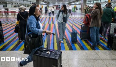 People queue to board a flight at Simon Bolivar International Airport in Maiquetia, near Caracas, Venezuela, 26 November 2025