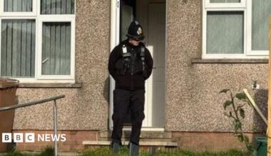 A policeman outside a property