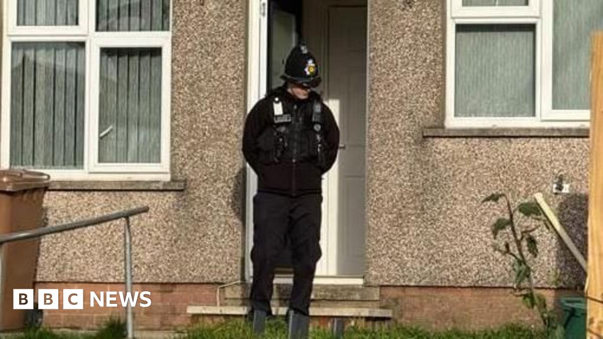 A policeman outside a property