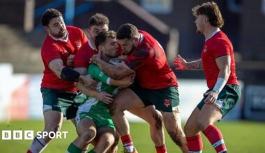 Wales players tackling an Irish player.