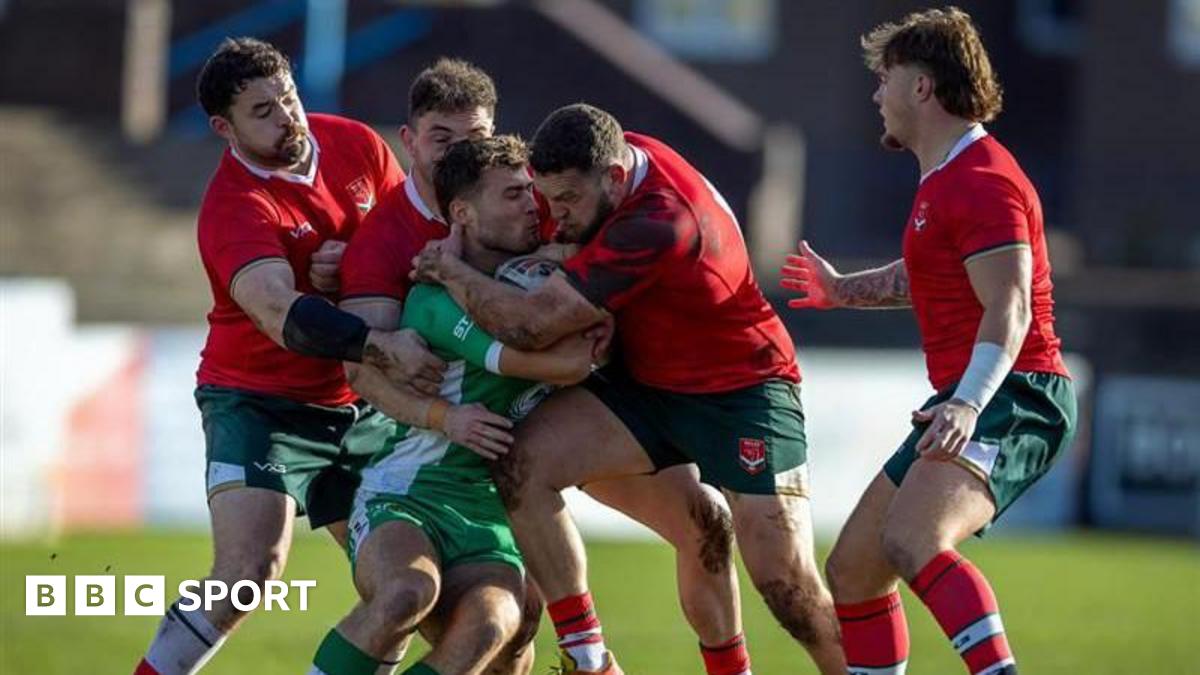 Wales players tackling an Irish player.