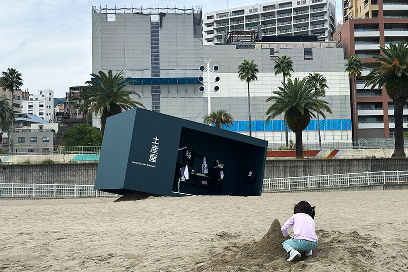 buried souvenir shop on japanese shoreline reflects on tourism, land, and memory