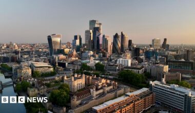 Day breaks over the City of London, with buildings visible including the Walkie Talkie and the Gherkin.
