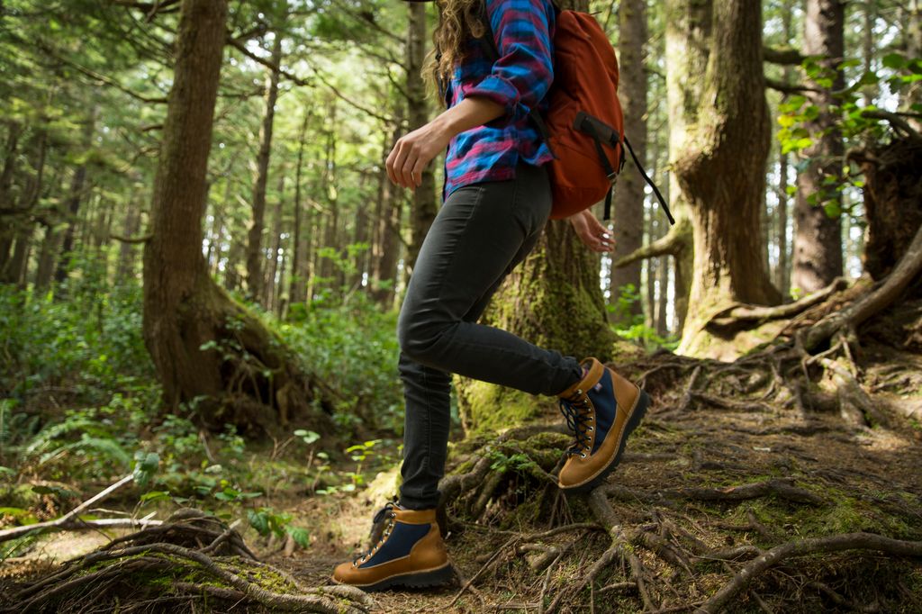 A woman hiking in a dense forest