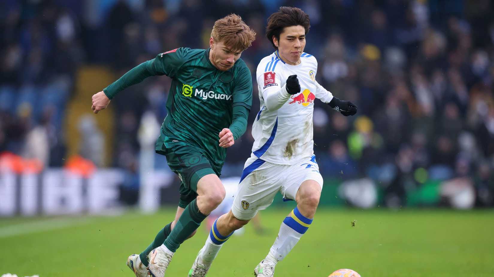 Millwall's Duncan Watmore in action with Leeds United's Ao Tanaka