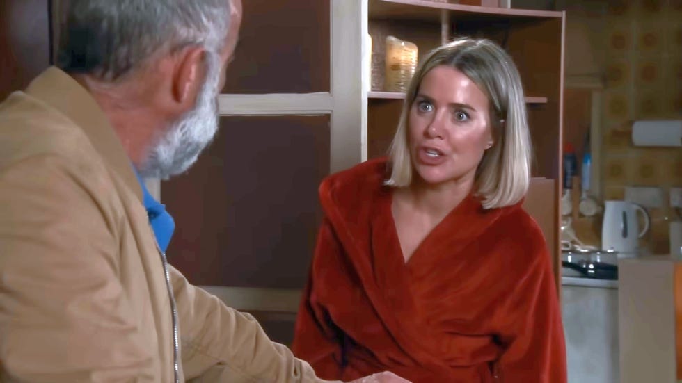 coronation street, kevin and abi webster aguing, kevin in a cream jacket and abi in a red dressing gown