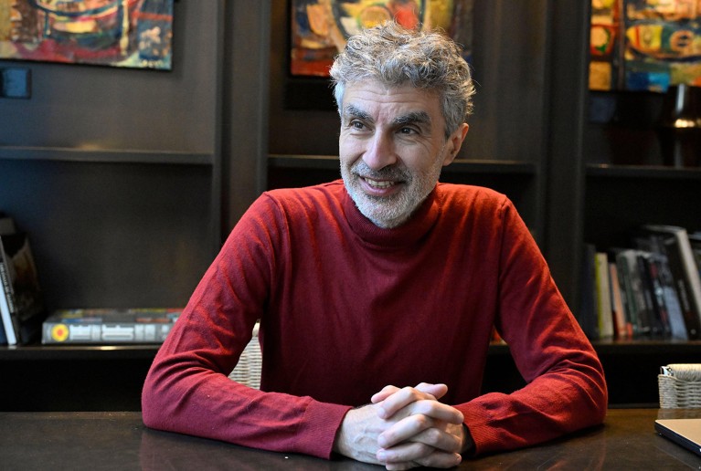 Professor of computer science Yoshua Bengio sat at a desk.