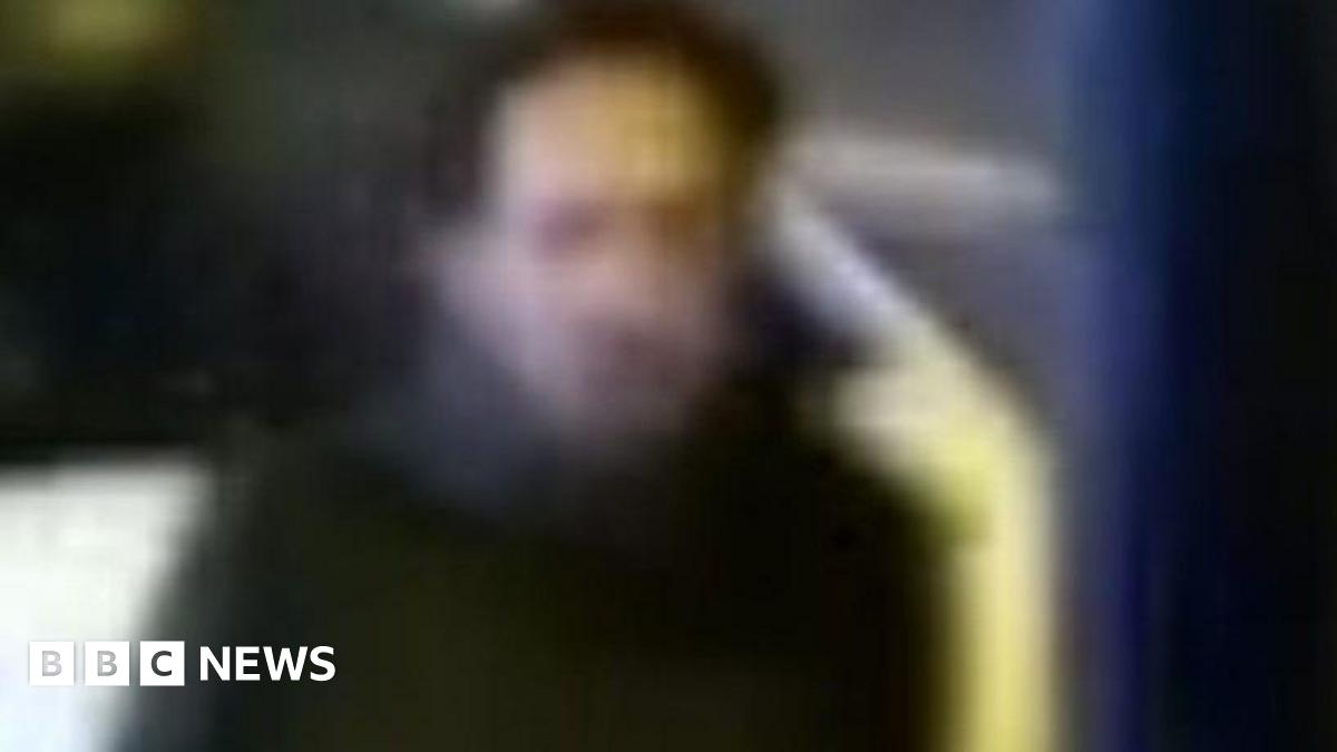 A CCTV image of a man police want to speak to. It is an unclear image which shows a man with dark hair wearing a dark coat.