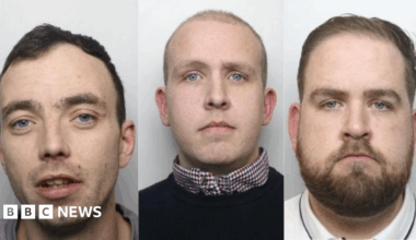 Police mugshots of three men, sat side by side. On the left is a man in his thirties with short dark hair. In the middle is a man with a closely shaved head, who is wearing a collared shirt and dark jumper. On the right is a man with short dark hair and a beard.