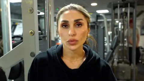 Roya Karimi in her gym, looking at camera