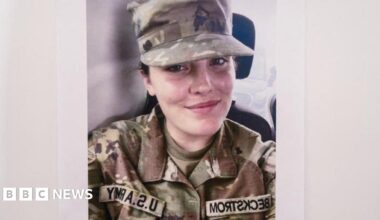 Sarah Beckstrom smiles in a selfie. She is wearing her camouflaged National guard uniform.