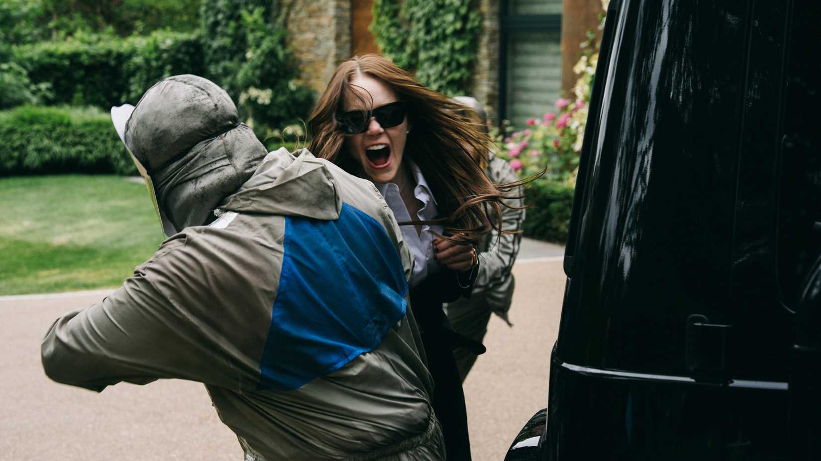 Emma Stone's Michelle fighting off being kidnapped by her car in Bugonia