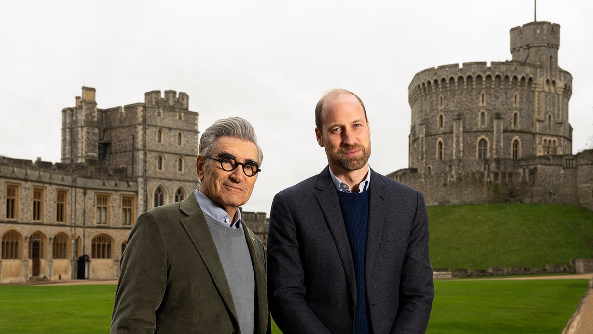 Eugene Levy and Prince William standing outside Windsor Castle.