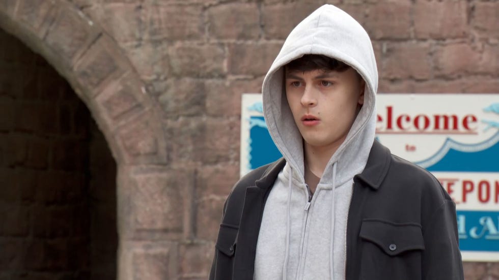 Hollyoaks, Ant Hutchinson hollyoaks, ant hutchinson standing outside with a white hood up