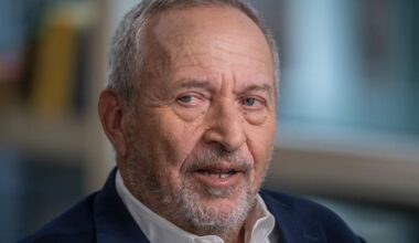 Larry Summers during an interview, looking slightly to the side with a neutral expression.