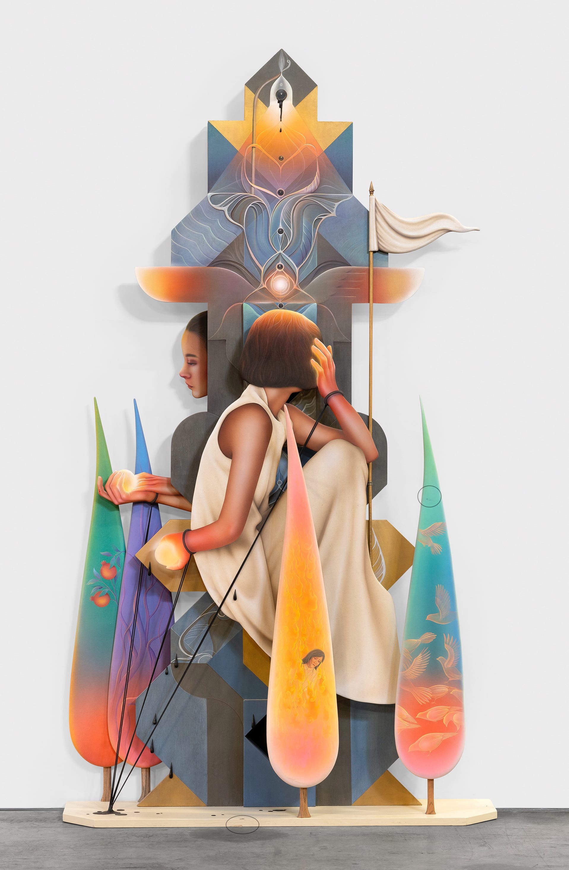 a tall layered sculpture by Arghavan Khosravi of women and and large-scale droplets with fish, fire, and more inside