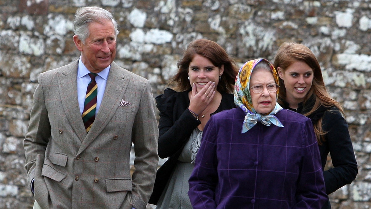 Princess Eugenie and Princess Beatrice laughing as they walk behind Queen Elizabeth and Prince Charles.