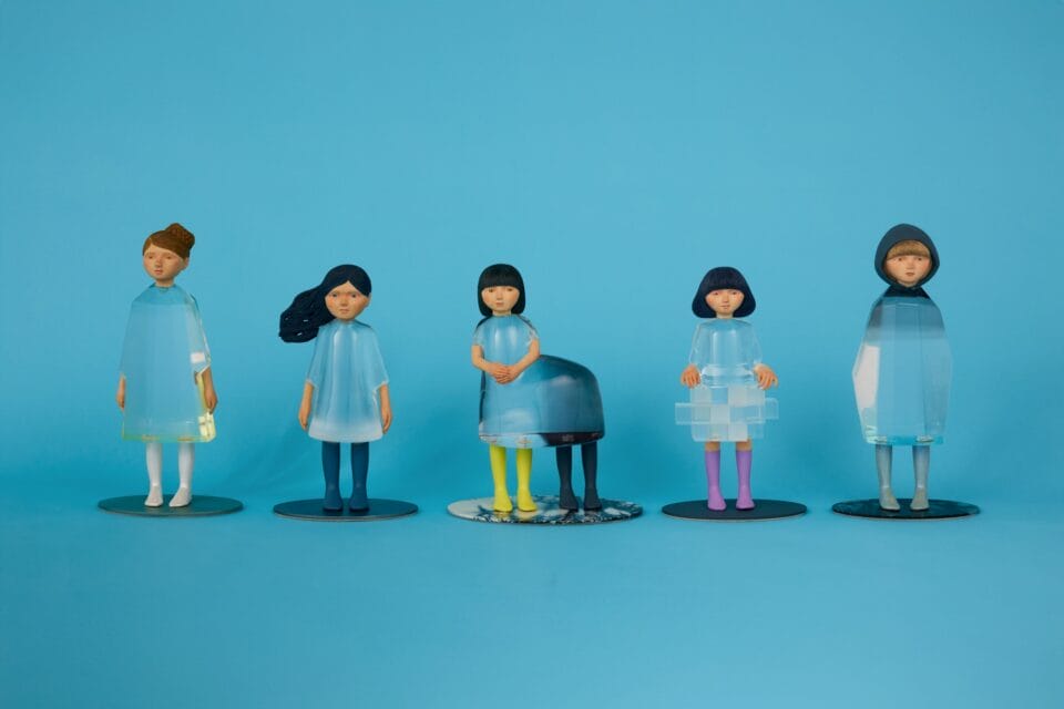 a series of five small sculptures by Ayako Kita made of cypress and acrylic resin, depicting young women or girls in various emotional states