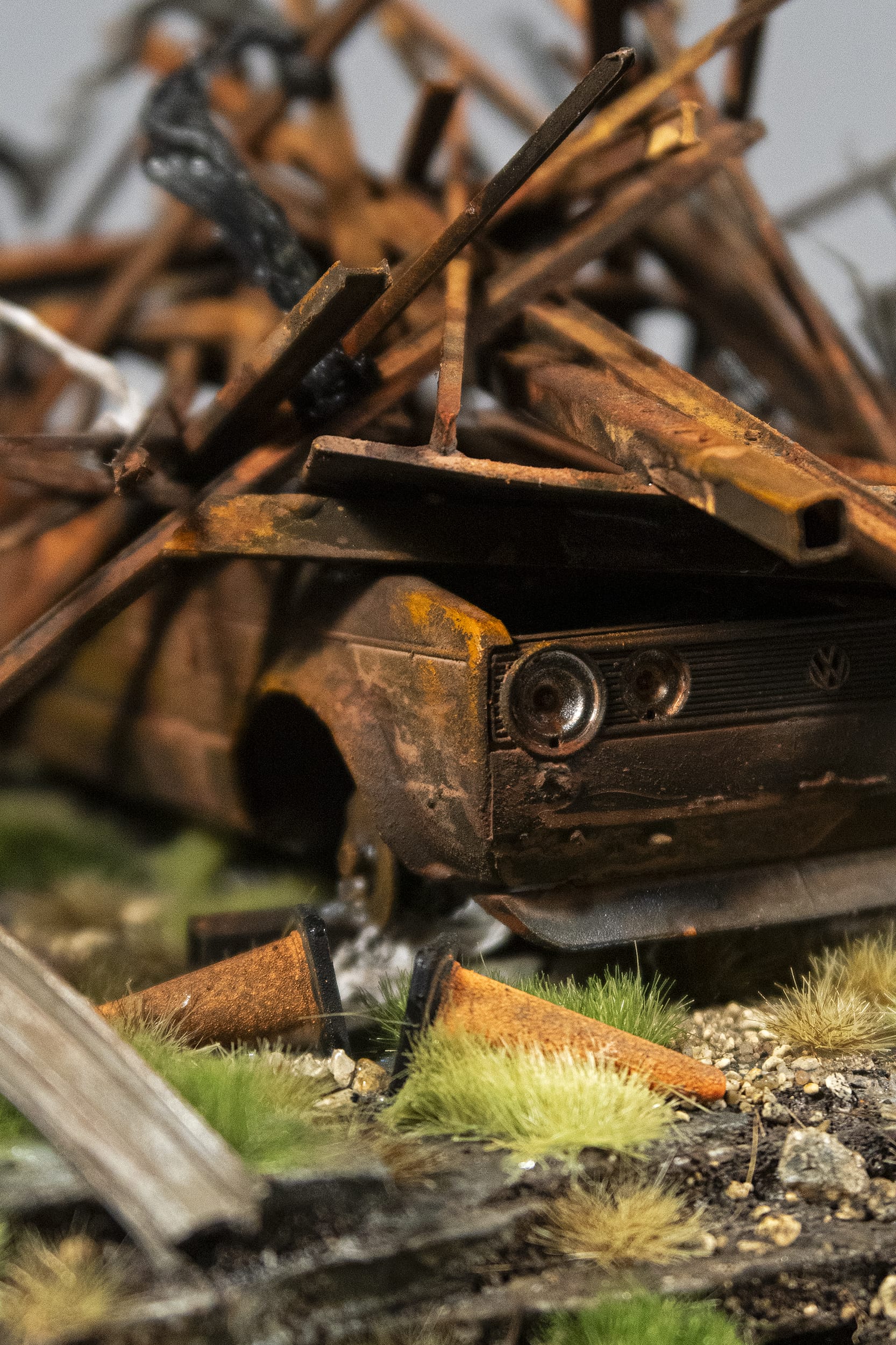 a detail of a hand-sculpted miniature by Simon Laveuve of a rusty, wrecked car