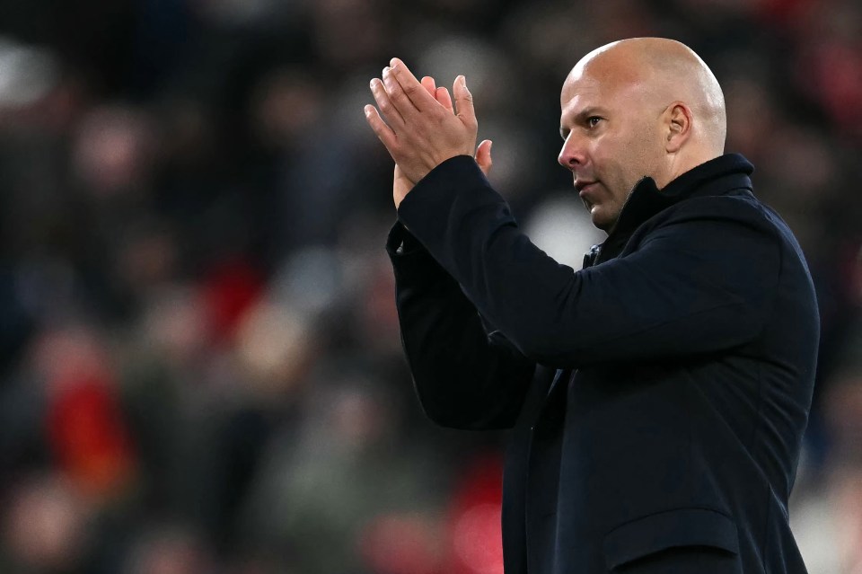 Arne Slot applauds the Liverpool fans after their victory against Aston Villa