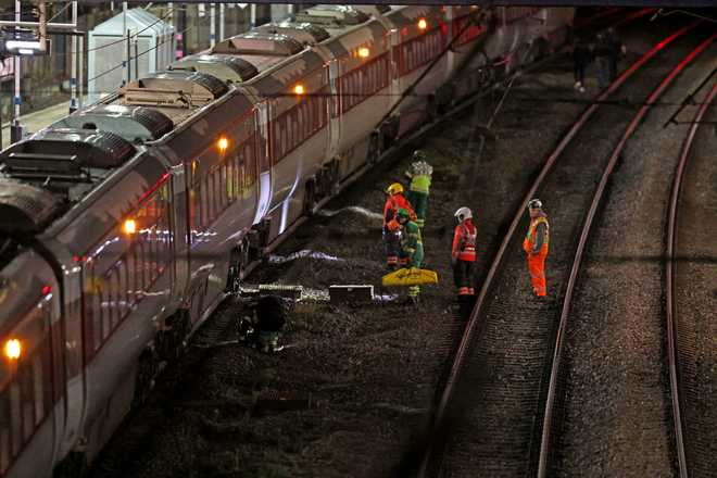 train station Emergency personnel inspect a train at the Huntingdon, England, train station in Cambridgeshire after people were stabbed Saturday, Nov. 1, 2025.