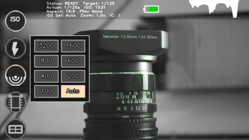 Close-up of a camera lens with an on-screen display showing ISO settings from 100 to 3200 and "Auto" highlighted. Camera status and details appear at the top. The image is in grayscale.