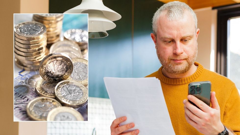 Man looking at tax form and phone