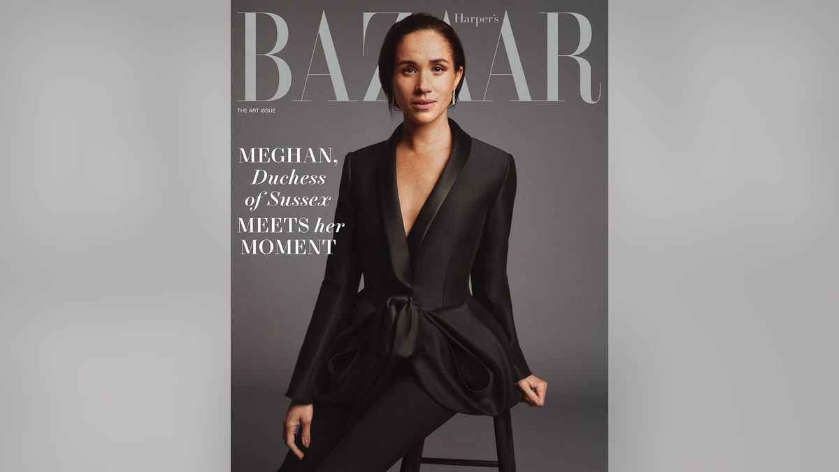 Meghan Markle wearing a low-cut V-neck black suit for the cover of Harper's Bazaar.