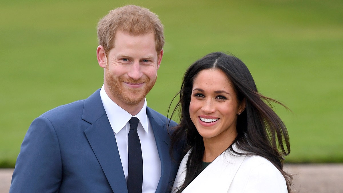 Prince Harry and Meghan Markle smile at Kensington Palace.