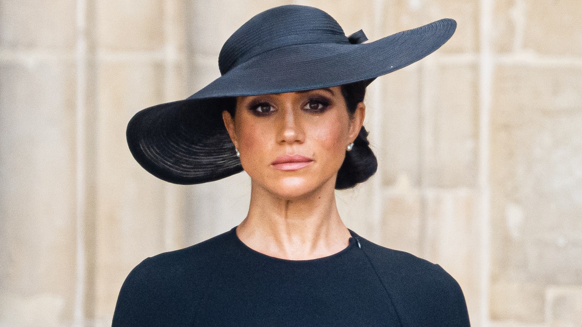 Meghan Markle wears a black dress and a black hat at Queen Elizabeth's funeral.
