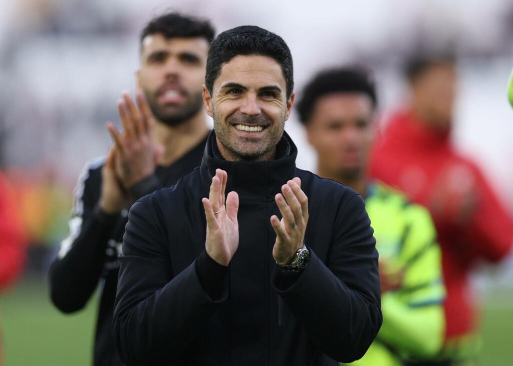 Mikel Arteta smiling and clapping aftert Arsenal win