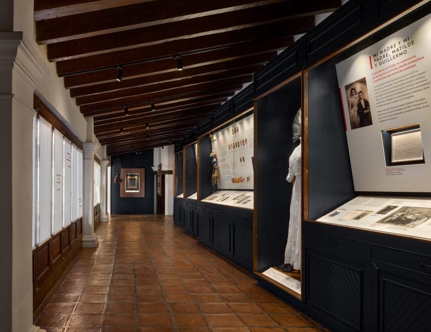 Exhibition includes historical family photos in a long room with an angled wooden ceiling