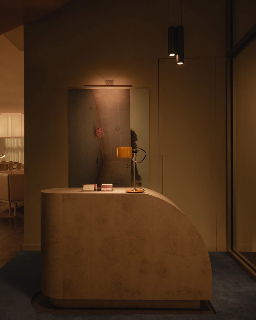 A sculptural stone host stand in a dimly lit space