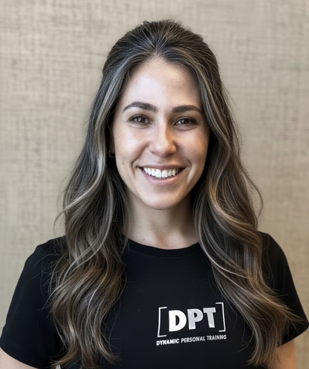 Head and shoulders of smiling woman wearing black T-shirt