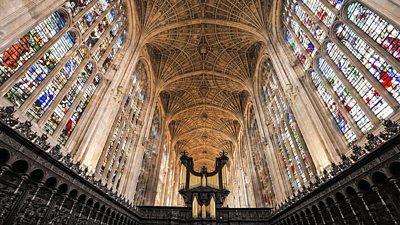 Interior of the chapel at King's College, Cambridge with a grand ceiling and stained glass windows